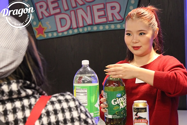 Student handing out mocktail at murder mystery night