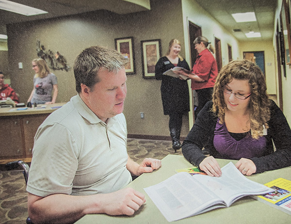 Julie working at the Career Development Center as a student