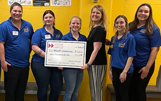 The Awesome Foundation Cass Clay present a check for a grant to the Oceanarium for World Oceans Day